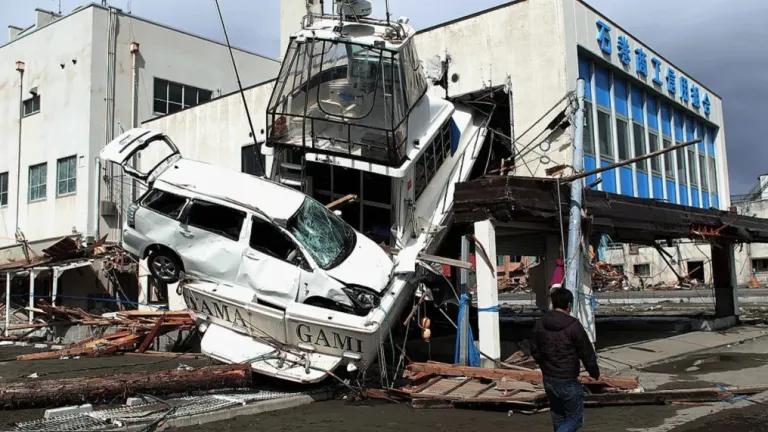 A person walks past tsunami wreckage in Ishinomaki, Japan, following the March 2011 earthquake and 10-metre wave that devastated the region.