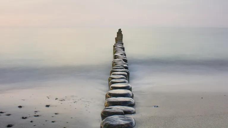 Image of stepping stones stretching out to the sea