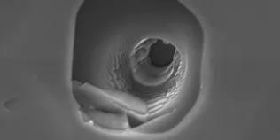 A 3D analysis pit image of a material sample using Secondary Ion Mass Spectrometry (SIMS) 