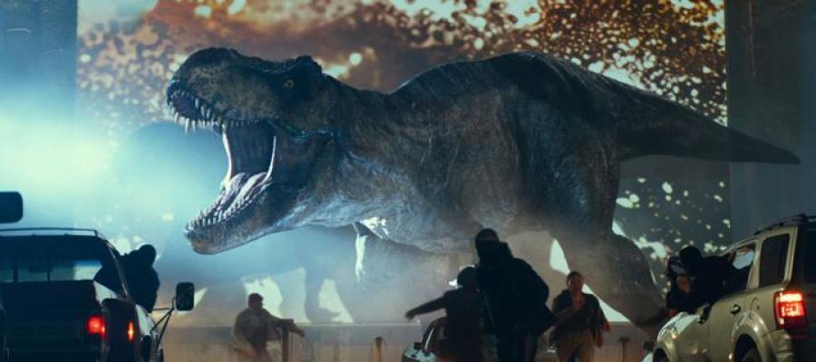 Image from the movie Jurassic World , where a T-Rex roars at a frightened crowd in a drive-in theatre