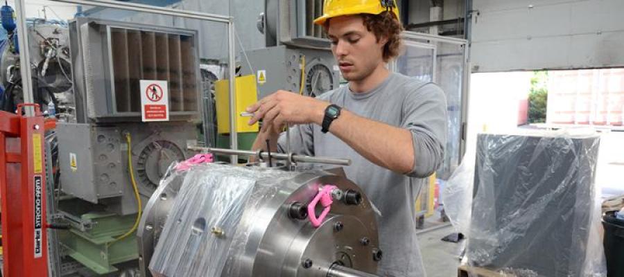 Student working in industrial setting