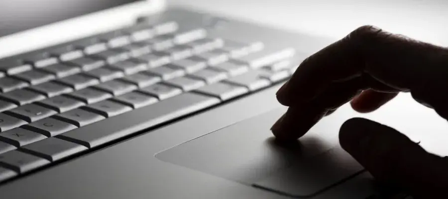 Close up view of a person using a laptop
