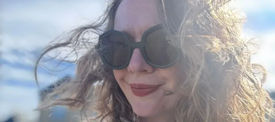 Close-up photo of Sarah wearing sunglasses