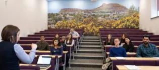 Students sitting in the Hutton Lecture Theatre watching a lecture.