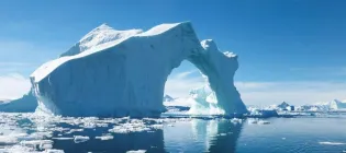 An iceberg in the middle of the ocean.