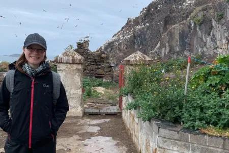 Amy posing for a photo in front of Bass Rock.