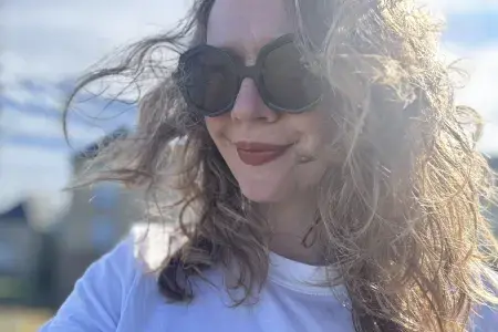 Close-up photo of Sarah wearing sunglasses