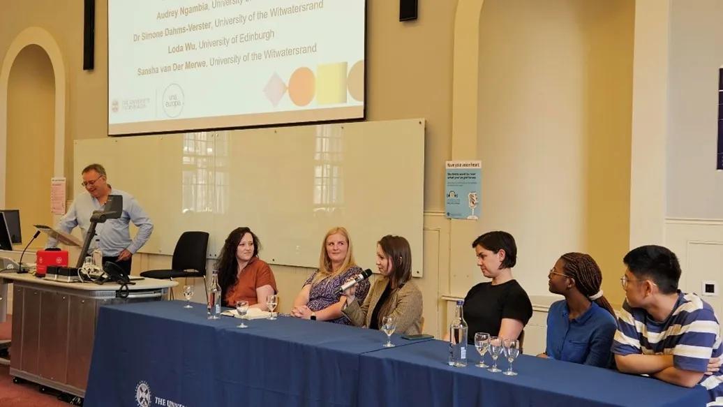 A group of people sitting at a table for a panel discussion