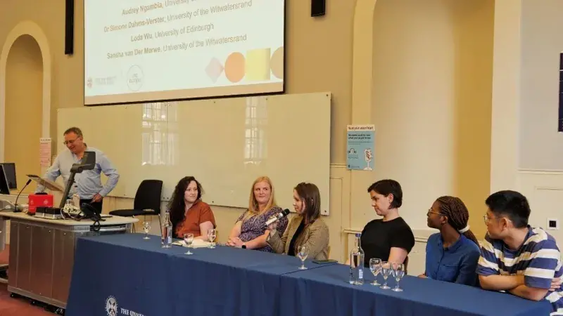 A group of people sitting at a table for a panel discussion