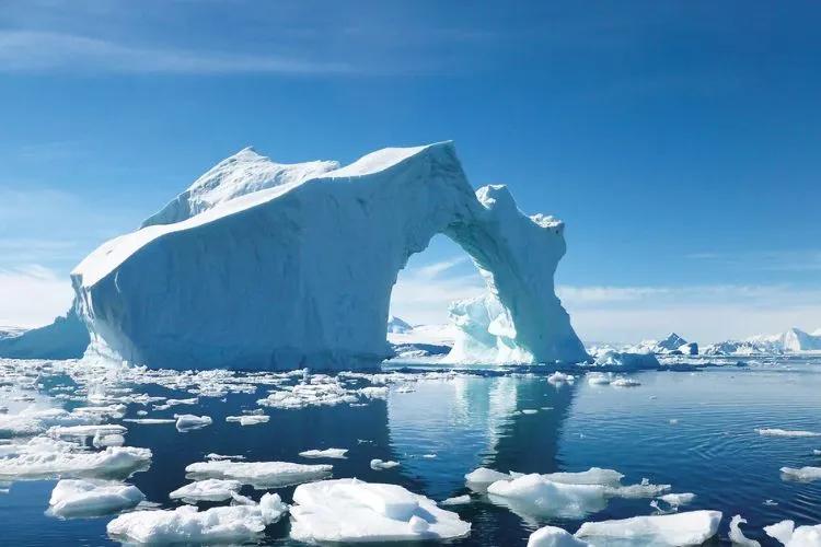 An iceberg in the middle of the ocean.