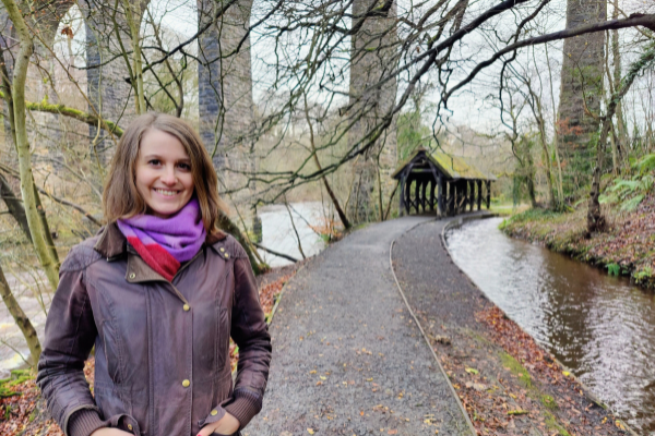 photo shows Erika standing outside near a river