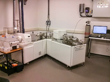 Inside a laboratory with a computer, gas tank and scientific equipment