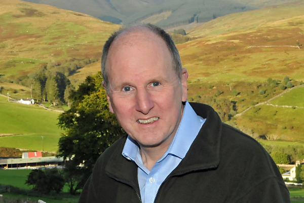 photo shows Angus with a hillside in the background